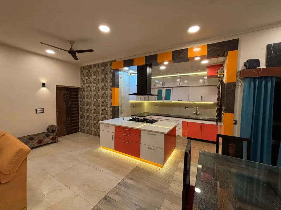 StayHolic lounge and open-kitchen interior.